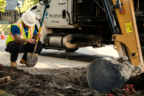 A Peoples Natural Gas utility worker provides direction during road excavation. April is Safe Digging Month, when Peoples reminds its customers to call 811 before all digging activity to best prevent striking underground utility infrastructure. (Photo: Business Wire)