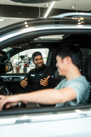 Walser Customer Specialist David Barrera discusses vehicle details with a customer at Walser Chrysler Jeep Dodge Ram in Hopkins, MN. (Photo: Business Wire)