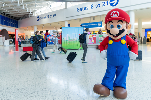 In this photo provided by Nintendo of America, Mario welcomes guests to the “Nintendo Switch On the Go” pop-up in the JetBlue terminal at John F. Kennedy International Airport in New York City, which enhances the family-friendly space with an area for travelers to play some of the latest titles for the Nintendo Switch.