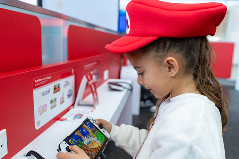 In this photo provided by Nintendo of America, a fan dives into a game using one of the game stations at the “Nintendo Switch On the Go” pop-up in JetBlue’s Terminal 5 in John F. Kennedy International Airport in New York City.
