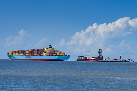 A Maersk container ship navigates along the Houston Ship Channel, the Great Lakes Dredge, and Dock’s dredge 