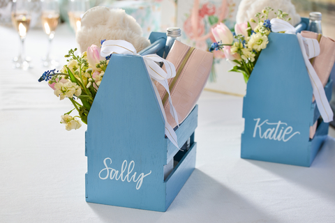 Give bridesmaid gifts a personal touch without overspending. 2X Ultra Cover Satin Spray in Satin French Blue transforms basic champagne caddies into cherished keepsakes. (Photo: Business Wire)