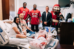 Fifth Third Bank Regional President Cary Putrino and Tampa Bay Buccaneers K.J. Britt and YaYa Diaby surprise the Hernandez family at AdventHealth Tampa with a $1,053 college savings gift. (Photo: Business Wire)