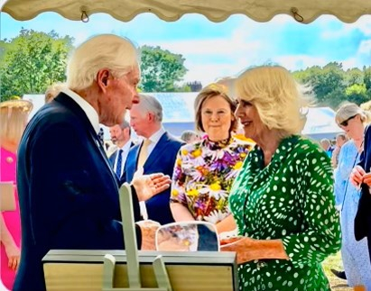 Following the 2023 Chelsea Flower Show, Parke Wright IV and Her Majesty The Queen at the Bee Garden Party in the gardens of Marlborough House. Her Majesty is the President of Bees for Development. Orchid Conservation Chelsea was invited to the Bee Garden Party to demonstrate pollinating orchids.(Photo: Business Wire)