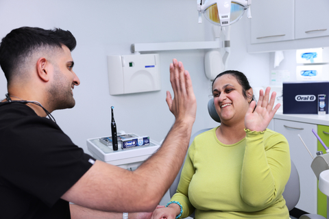 Dr Vikas Prinja with a patient in his dental practice in London, and one of the first dental professionals to become a Disability Champion through the new awards programme from Oral-B and the iADH. (Photo: Business Wire)