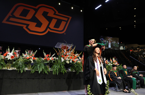 Caitlin Cosby is hooded by Dr. Natasha Bray during the Oklahoma State University College of Osteopathic Medicine commencement ceremony in Tulsa, Okla., on Thursday, May 16, 2024. Cosby was among the inaugural class of students from the College of Osteopathic Medicine at the Cherokee Nation in Tahlequah, Okla. (Photo: Business Wire)