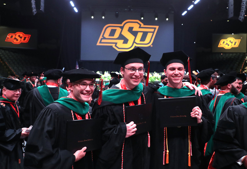 Jonas Weygandt (left), William Redmond and Colton Smith (right) gather for a photo after the Oklahoma State University College of Osteopathic Medicine commencement ceremony in Tulsa, Okla., on Thursday, May 16, 2024. The trio were part of the first graduating class from the College of Osteopathic Medicine at the Cherokee Nation (Photo: Business Wire)