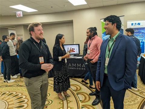 David DeLisle (The Ohio State University) and Nikhil Biju (Gamma Technologies) in the foreground and Vivek Pisharodi (Gamma Technologies) speaking with Isabel Builes (California State University, Los Angeles) in the background at the Battery Workforce spring competition. (Photo: Business Wire)