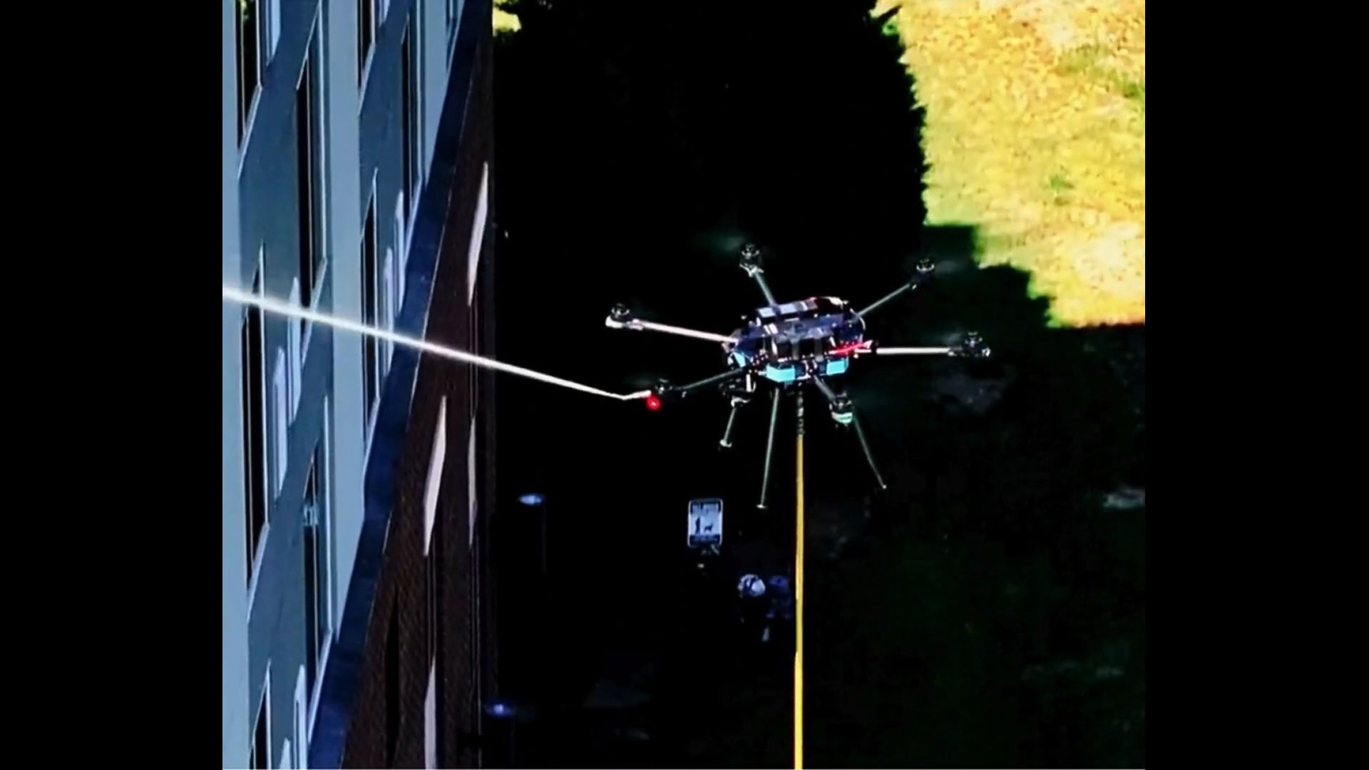 Remote controlled drone power washing a hotel.