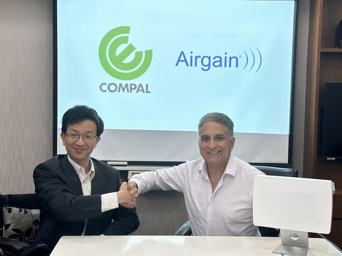 Yiyun Chang, Vice President at Compal Electronics, Inc. (left), shaking hands with Dr. Ali Sadri, CTO of Airgain Inc., after signing a strategic MOU. (Photo: Business Wire)