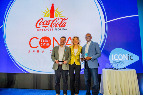 original Terrence Gee, (right) senior vice president, Technology and Enterprise Transformation for Coca-Cola Beverages Florida, LLC, accepts the Blue Yonder 2024 ICONic Award for Supply Chain Resiliency. He is joined by (left-right) Baron Jordan, chief product officer - supply chain, CONA Services LLC and Susan Beal, chief customer officer, Blue Yonder. (Photo: Business Wire)