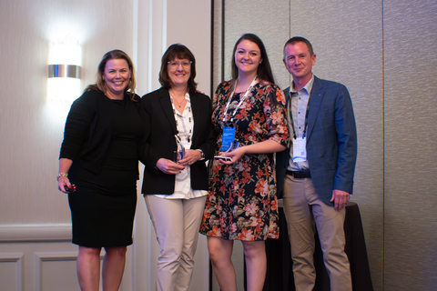 Presenter Kelly Woodsum (far left) and Richard Steward, EVP Americas Software, Körber Business Area Supply Chain (far right) embrace honorees Miriam Steuart (center left) and Brianna Henthorn of Ecolab (center right) for a photo op (Photo: Business Wire)