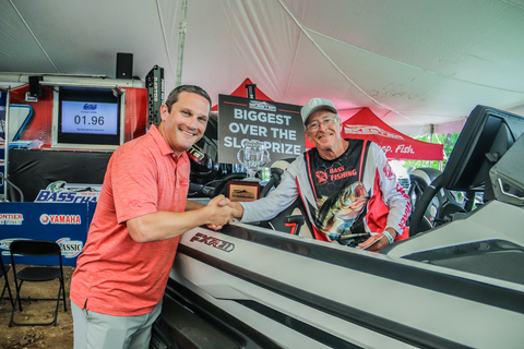 Skeeter General Manager, John Clark congratulates Bernard Gunn, the biggest over the slot winner for the 2024 Skeeter Owners' Tournament. Bernard sits in his grand prize, the 2024 Skeeter FXR21 Apex Edition. (Photo: Business Wire)