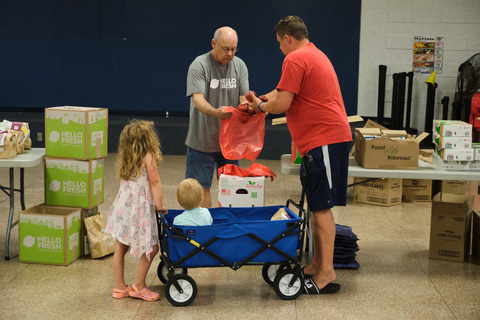 Families pick up food at a HelloFresh and No Kid Hungry 13 for 13M distribution event. (Photo: Business Wire)