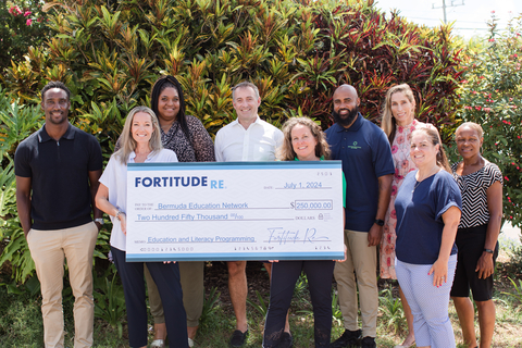 Amanda Stewart, Head of Employee Experience, Fortitude Re and BEN Board Member presents the $250,000 check to Becky Ausenda, Bermuda Education Network’s founder on the opening day of Fortitude Re's Summer Reading Program. (Photo: Business Wire)
