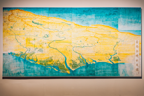 Using old newspapers as underlay, artist Lin Chien-chin creates his work layer upon layer by drawing maps of Tainan from different historical periods, displaying the relationship among mankind, land, and water that has shaped Tainan’s contemporary landscape. (Photo: Business Wire)