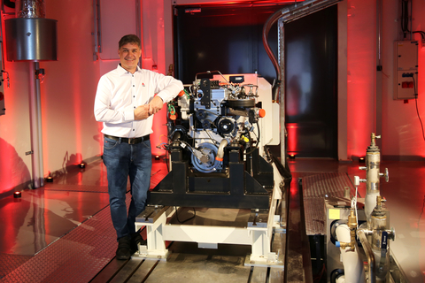 AGCO Power's Director of Engineering Kari Aaltonen in front of a hydrogen combustion engine in the new Clean Energy Laboratory. (Photo: Business Wire)