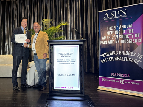 Dr. Verrills presenting the Top Abstract Award to Dr. Beall for his presentation on the clinical results of the HYDRAFIL System out to three years in patients with chronic low back pain due to degenerative disc disease. (Photo: Business Wire)