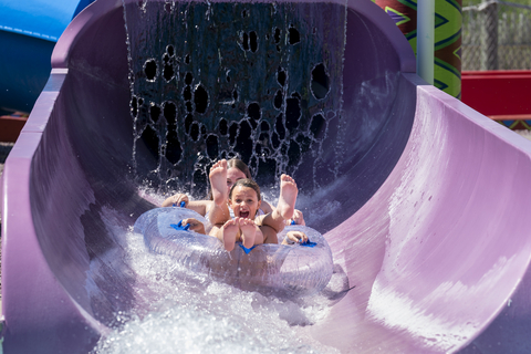 A brother and sister splash down a tube slide at Kalahari Resorts’ outdoor waterpark in celebration of National Waterpark Day. (Photo: Business Wire)