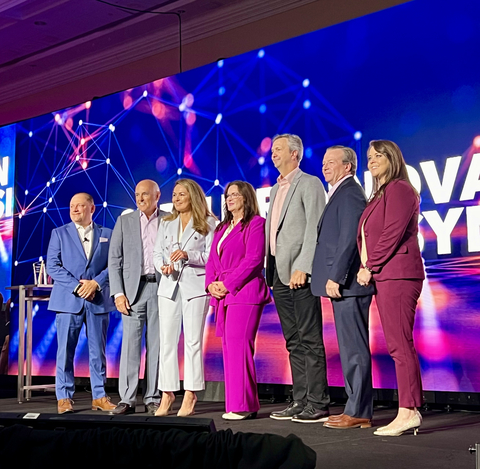 From left to right: Tony Eaton , Global Supply Chain Director at Leidos; Paul Smith, CEO at Rancher Government; Sima Shahin, RVP Business Development at Rancher Government; Stephanie Foster, SVP and Chief Supply Chain Officer at Leidos; Mike Byrd, VP Ecosystems at Rancher Government; Don Poole, VP Corporate Communications and Marketing at Rancher Government and Carly Kimball, Chief Performance Officer at Leidos. (Photo: Business Wire)