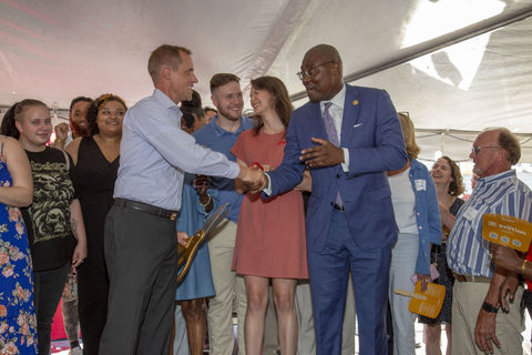 Immerse Arkansas Executive Director Eric Gilmore, left, shakes hands with Little Rock Mayor Frank Scott Jr. after cutting the grand opening ribbon for The Station, a homeless shelter for at-risk young adults in Little Rock, Arkansas. (Photo: Business Wire)