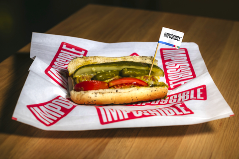 The world-famous smoky, savory Impossible™ Hot Dog dished up Chicago Style on a poppy seed bun with mustard, sweet relish, white onion, tomato, sport peppers, dill pickle spear, and celery salt. (Photo: Business Wire)