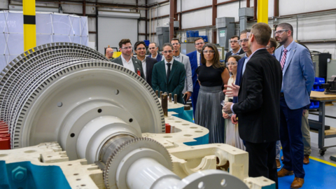 The Oklo team in discussion with Siemens Energy on the industrial steam turbine at Siemens Energy's Houston office (Image: Oklo)