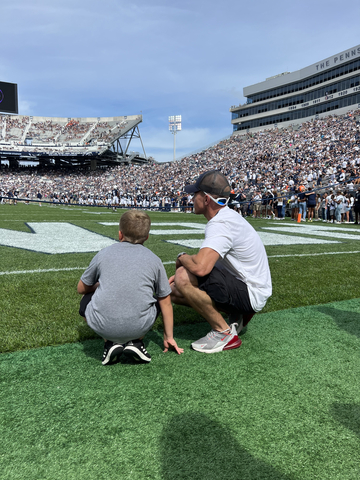 A Four Diamonds ‘Kick-Off Kid’ prepares to retrieve the tee after a Penn State Football opening kickoff (Photo: Business Wire)