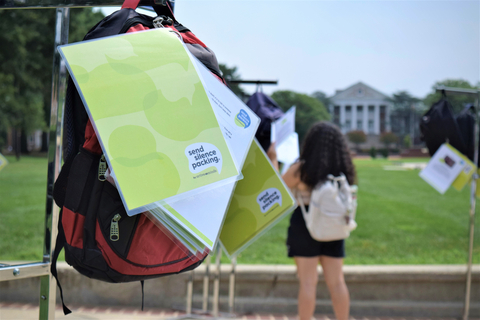 A college student reading one of the 100 personal stories on the 100 backpacks in the Send Silence Packing exhibit (Photo: Business Wire)