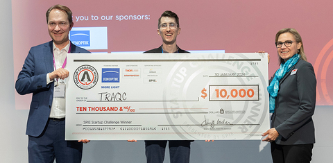 The winning shot at the SPIE Startup Challenge in 2024: Jenoptik's Ralf Kuschnereit, TRAQC's Benjamin Dringoli, and 2024 SPIE President Jennifer Barton. (Photo: Business Wire)