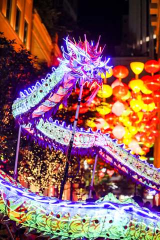 Young dragon dancers carrying a dragon decorated with 10,000 LED bulbs, showcasing the passing on of this traditional heritage. (Photo credit: Hong Kong Tourism Board)