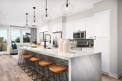 The homes at Round Barn include modern conveniences and classic styling; features include all-electric appliances, smart built-in tech, and owned solar systems; pictured is the kitchen of the Plan 1 Model Home. (Photo: Business Wire)