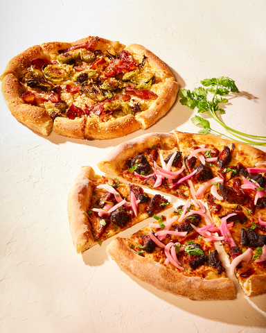 California Pizza Kitchen debuts brand-new Burnt Ends BBQ Pizza and returning fan-favorite Bacon & Brussels Pizza for National Pizza Month. (Photo: Business Wire)