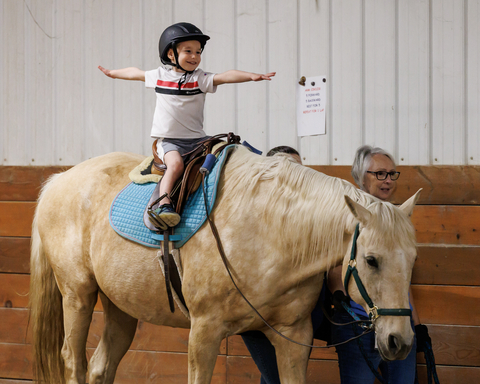 Young rider Josiah learns confidence balancing on Rio, a SMILES program horse (Photo: Business Wire)