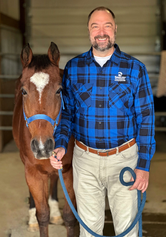 Troy Moldenhauer, Executive Director of SMILES poses with Rodney, a SMILES program horse (Photo: Business Wire)