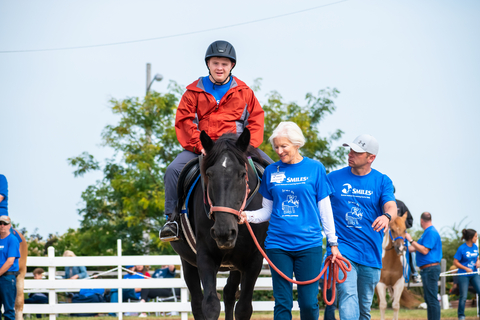 Nic works hard on his goals during a session on his trusted horse, Judy. (Photo: Business Wire)