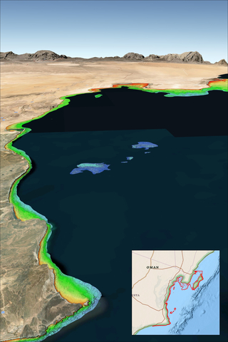 TCarta Satellite Derived Bathymetry (SDB) on the Oman Coast indicates shallow water depths by color – red represents 0-3 meters, yellow is 3-6 meters, green is 6-10 meters, turquoise is 10-14 meters, and blue is 14-18 meters deep. Inset map indicates geographic location of data set. (Credit: TCarta Marine)