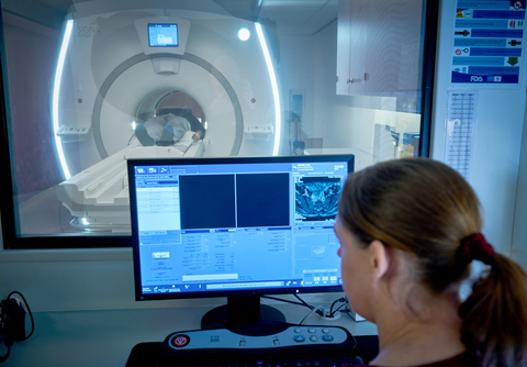 A radiologist looking at MRI exam images (Photo: Business Wire)