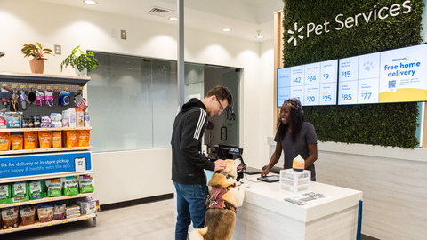 Walmart Pet Services staff greets customer and their dog (Photo: Business Wire)