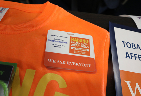 original A Northwell Health firearm safety awareness badge rests on a gun violence prevention t-shirt. (Credit: Northwell Health)
