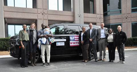 Assurant, through the Assurant Foundation, teamed with Wounded Warrior Family Support (WWFS) to present combat-wounded veteran Stephanie Johnson with a mobility-modified 2024 Chevy Tahoe SUV on October 28, 2024. Pictured left to right: Monica Bomani, Director of Social Impact, Assurant; Suzanne Shepherd, SVP, Global Communications & Sustainability, Assurant; Lance Johnson (holding child); Stephanie Johnson; Assurant President and CEO Keith Demmings; Assurant SVP and incoming President of Assurant Global Automotive, Jeff Strickland; La Shonda Oglesbee, VP, Global Diversity, Equity & Inclusion, Assurant; and Dan Barone, Assurant VP and Executive Sponsor of Veterans@Assurant Employee Resource Group. (Photo: Business Wire)