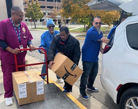 Corvias team members unloading boxes full of donations at the John D. Dingell VA Medical Center in Detroit. (Photo: Business Wire)