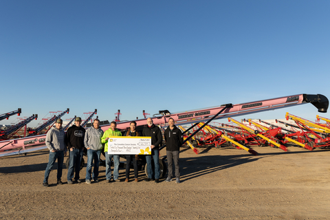 Surrounded by a yard of conveyors, family members of Bolt Seed Farm, Wynyard, SK -- Wyatt Bolt, Walker Bolt, Tod Bolt, Scott Bolt -- join Rodger Lohman, Canadian Cancer Society; and AGI’s Tom Firth and Ryan Campion to celebrate $66,375 CAD raised in AGI's Pink Conveyor for a Cause campaign for cancer awareness. Bolt Seed Farm secured the high bid. (Photo: Business Wire)