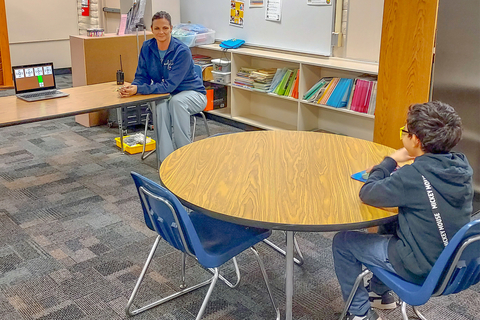 A school nurse conducts a vision screening with a student using the EyeSpy 20/20 technology; the tool accurately captures critical vision data while to the student, it is more like participating in a computer game. Photo courtesy of Mesa Public Schools.