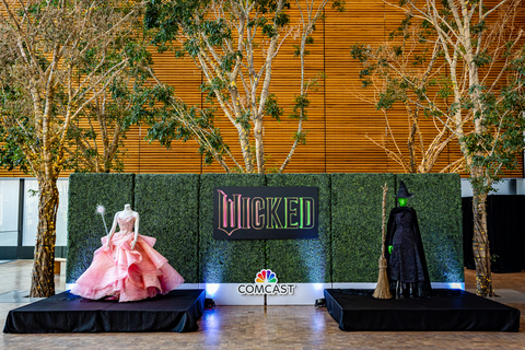 The signature costumes of Glinda and Elphaba, as worn by Ariana Grande and Cynthia Erivo in Universal Pictures' cinematic event Wicked, on display in the Comcast Technology Center in Philadelphia. (Photo: Comcast)