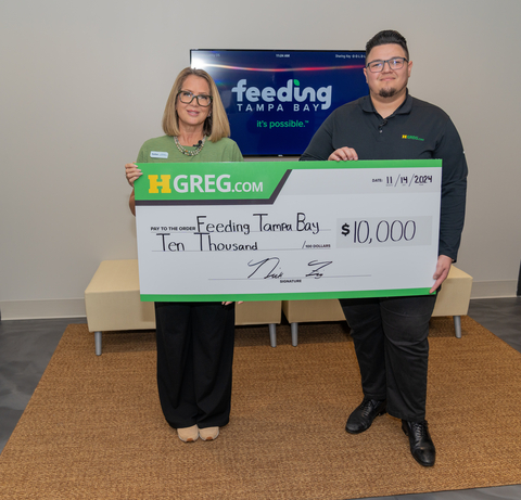 Nick Figueroa, Senior Sales Manager, HGreg Tampa, presents a check of $10,000 to Shannon Oliviero, Media and Public Relations Officer, Feeding Tampa Bay, to help rebuild the city after hurricane season, November 14, 2024. (Photo: Business Wire)