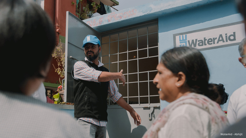 WaterAid India team member showing the improved toilets at an Anganwadi center. (Photo: WaterAid - Abhijit)