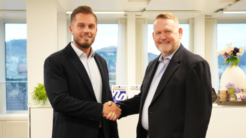 Besfort Kuqi, CEO of Swiss GRC, and Joseph Brewer, CEO of OpResONE, Inc., shake hands during the official signing ceremony at Swiss GRC's Global Headquarters in Lucerne, marking the start of their strategic partnership. (Photo: Business Wire)