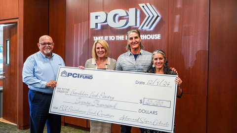 Tina Tavares Powderly (right), Executive Director of Franklin Food Pantry, is all smiles after being presented with a grant from PCI for her organization. Sharing the moment are (from left) PCI's Ismael Diaz, President & CEO, and Founders Arturo and Susan Echarte. The handover took place at the annual PCI Powerhouse Fund Gratitude Gathering Event at PCI's Southeast headquarters in Florida. (Photo: Business Wire)