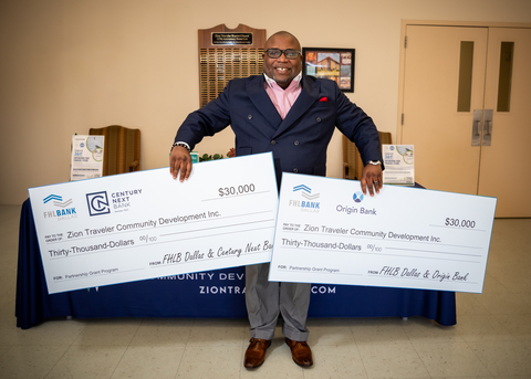 Rev. Maurice White, pastor of Zion Traveler Baptist Church, holds two checks totaling $60,000 each from FHLB Dallas, Century Next Bank and Origin Bank. (Photo: Business Wire)